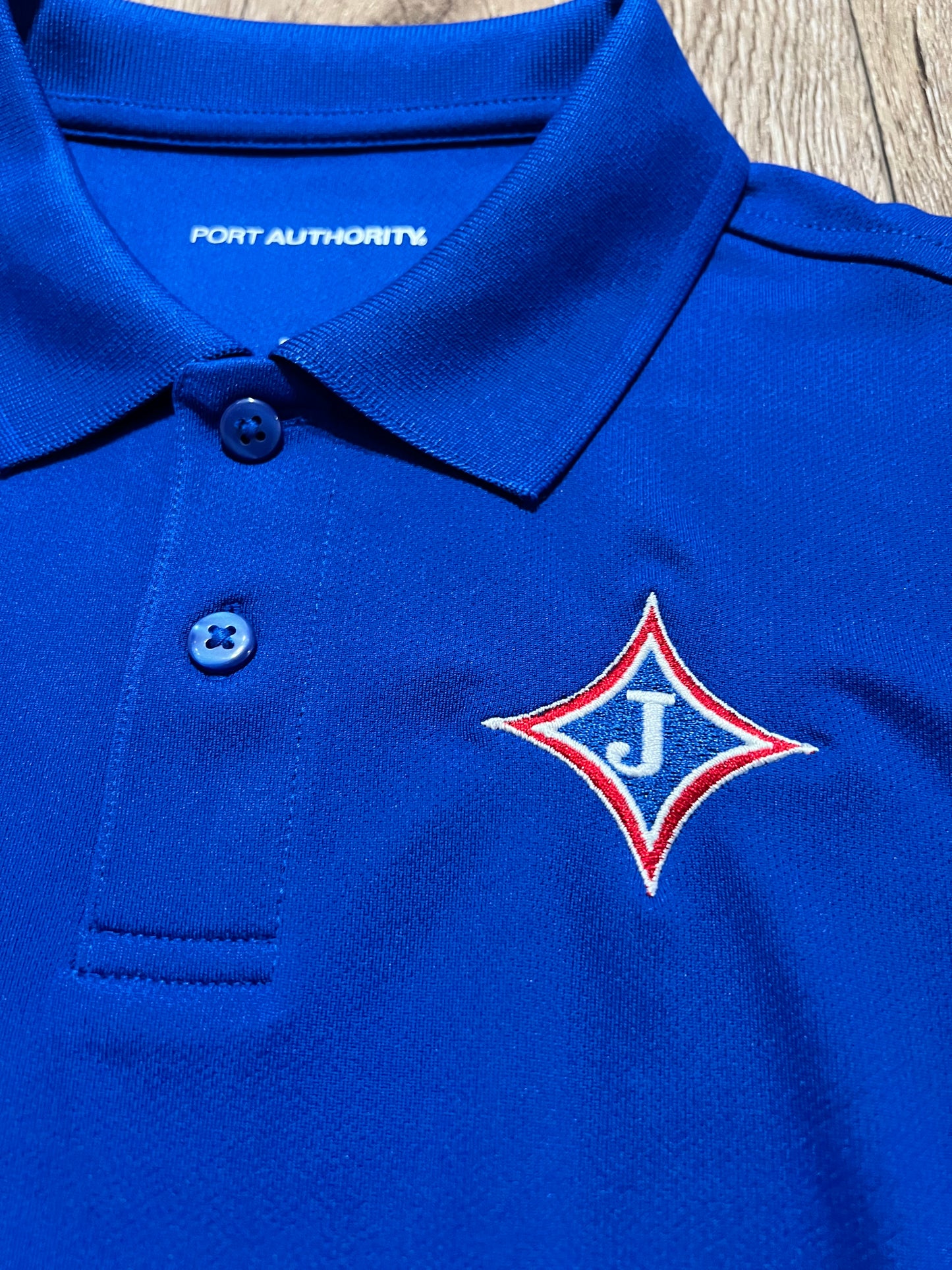 Youth Short Sleeve Moisture Wicking Polo with school logo