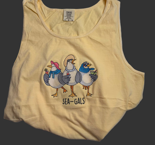 Yellow tank top with 'Sea-Gals' graphic design on a grey background