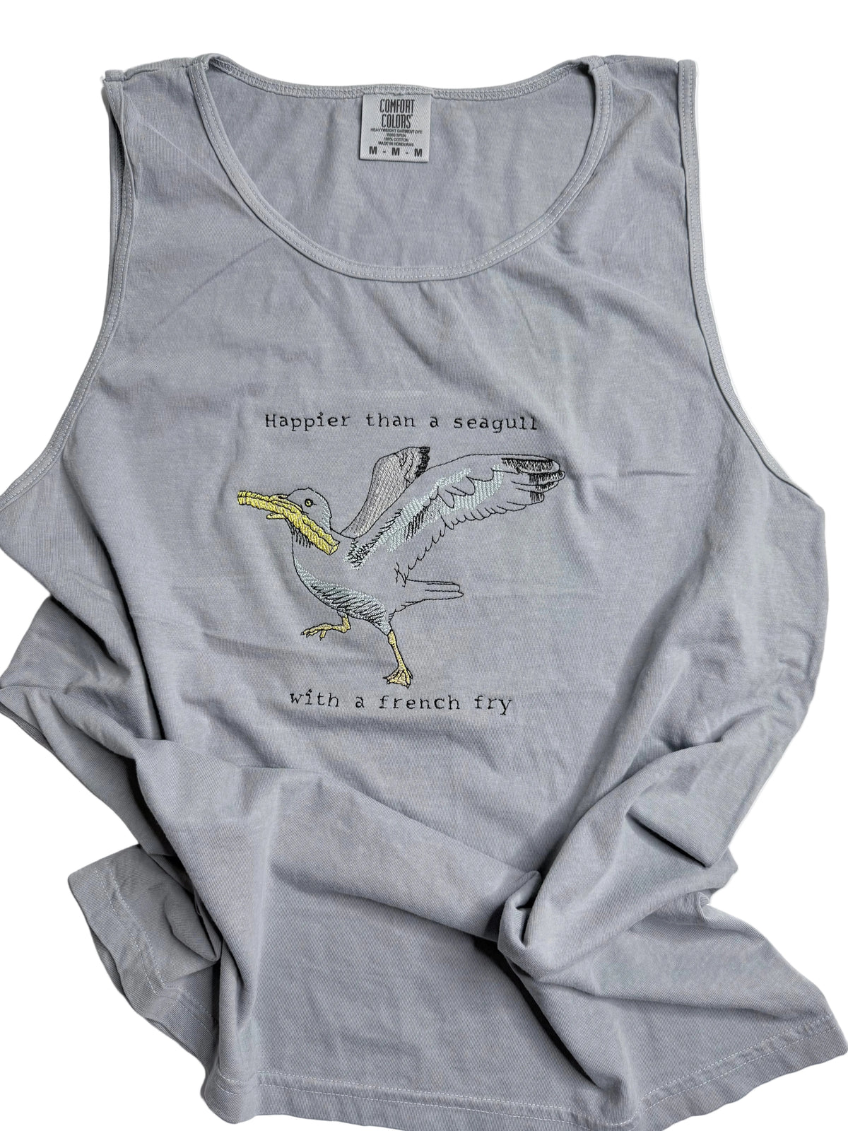 Gray tank top with a graphic of a seagull with a french fry and text on a white background