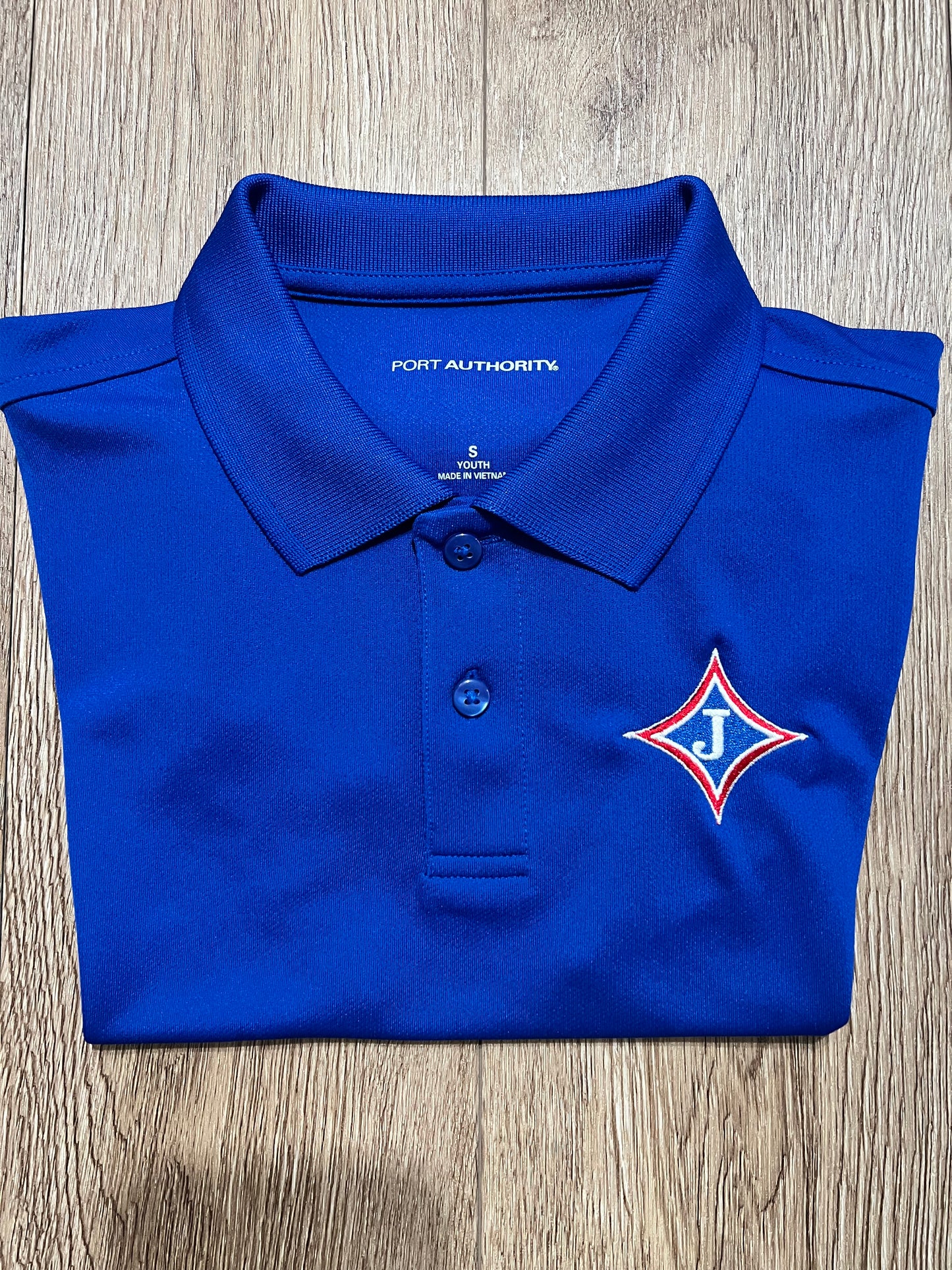 Youth Short Sleeve Moisture Wicking Polo with school logo