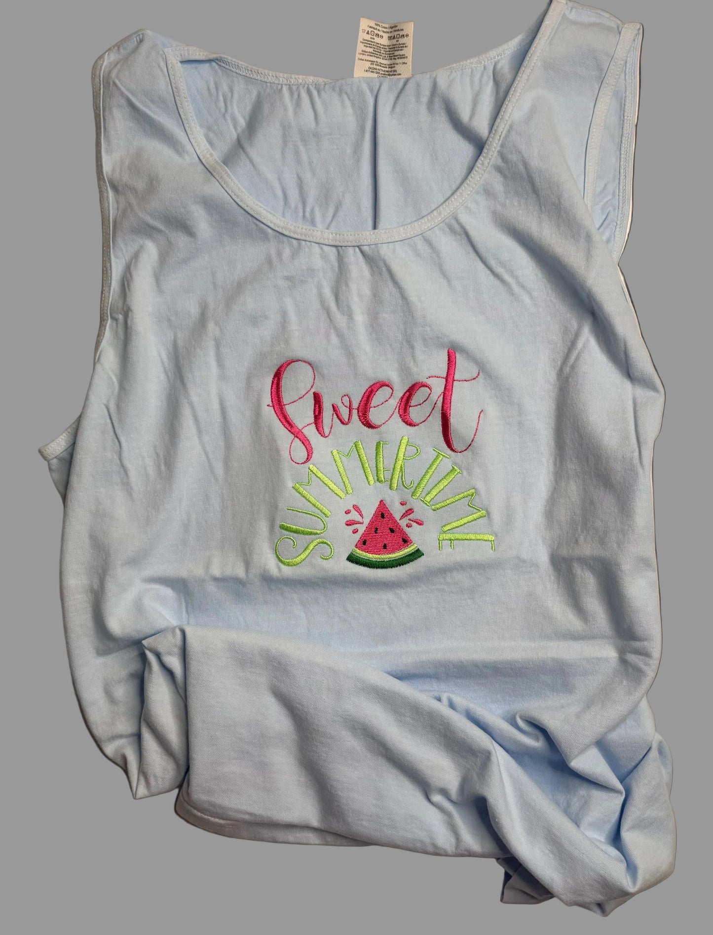 Light blue tank top with 'sweet summer' text and watermelon design on a gray background
