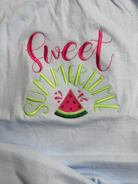 Embroidered text 'Sweet Summer Time' with a watermelon slice on a light blue fabric background.