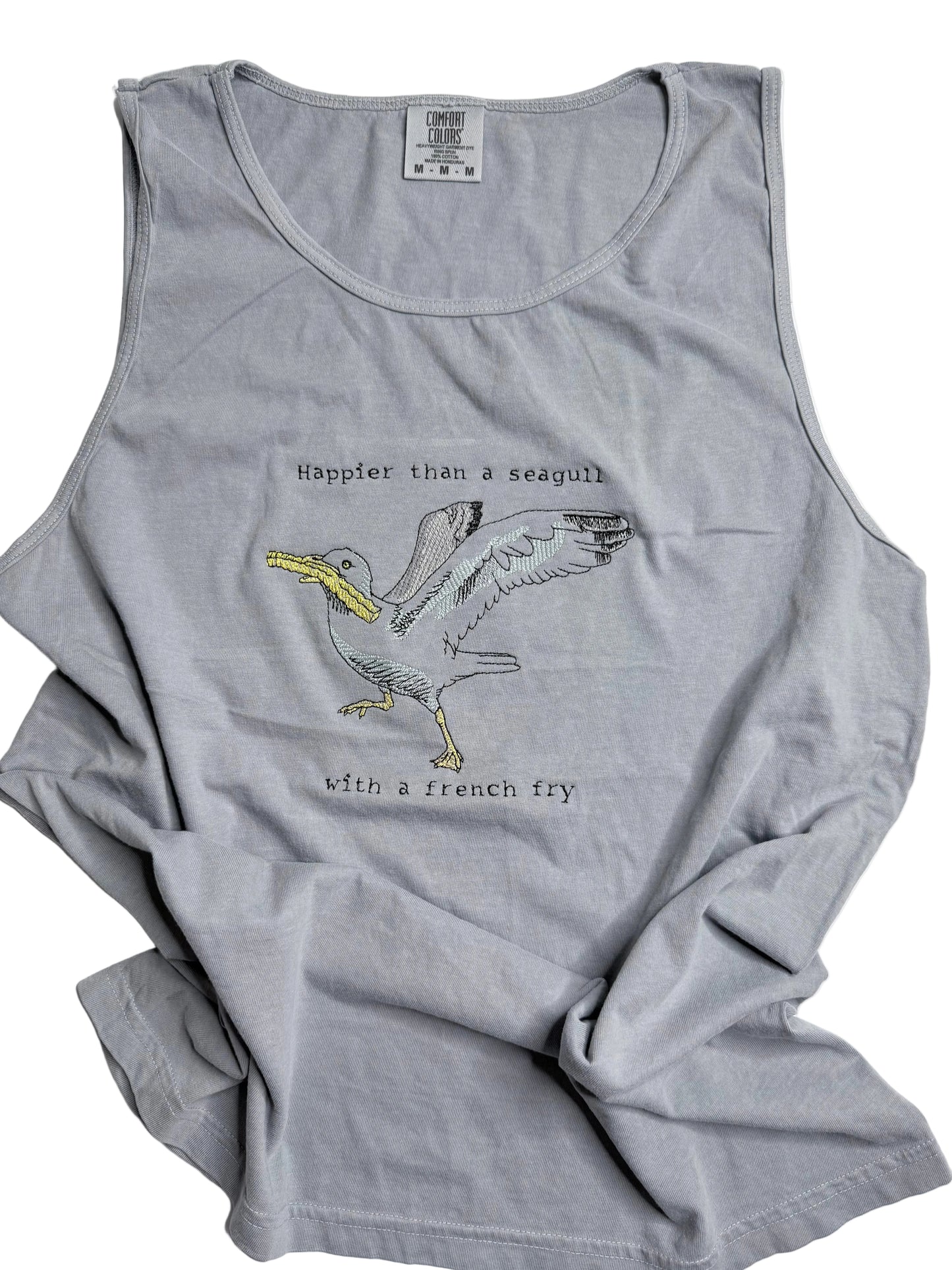 Gray tank top with a graphic of a seagull with a french fry and text on a white background
