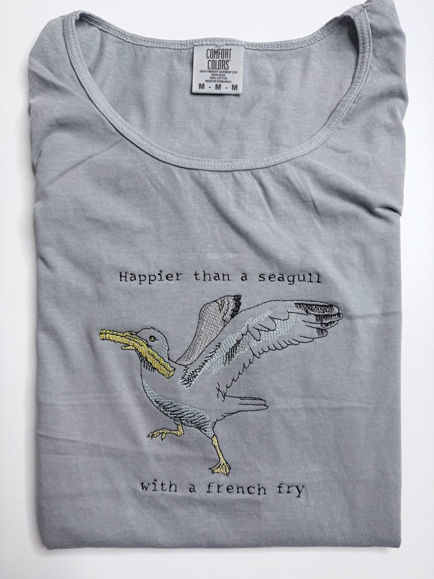 Gray tank top with a seagull graphic and text on a white background