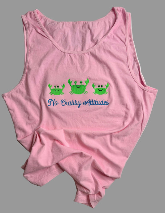 Pink tank top with green crabs and text on a gray background