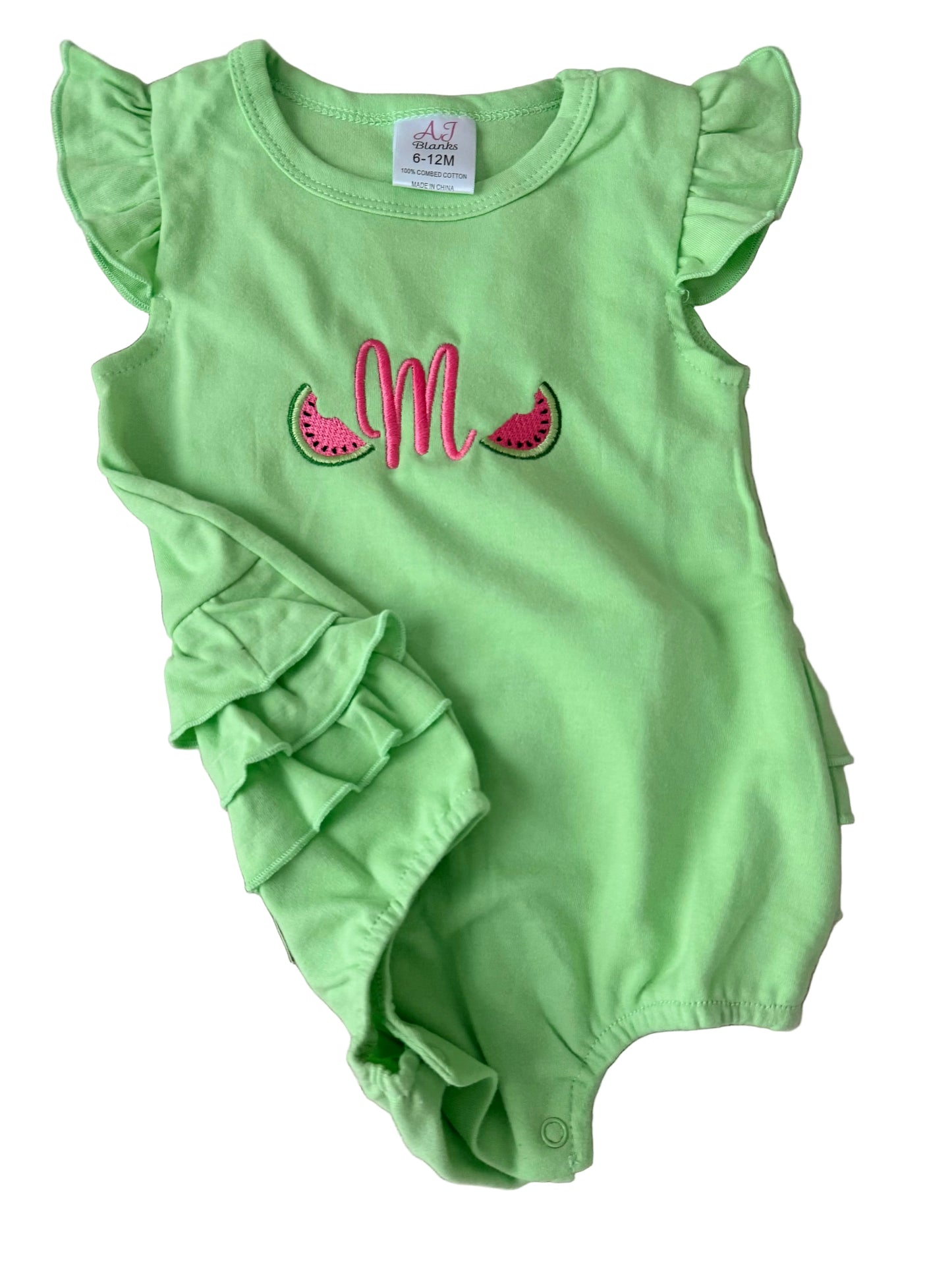 Green baby romper with ruffled sleeves and watermelon design on a white surface
