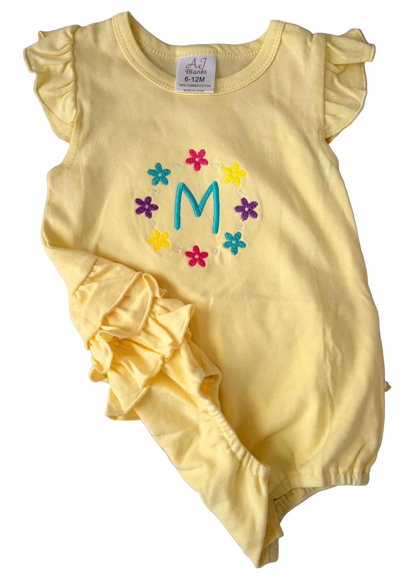 Yellow baby romper with colorful flowers and letter 'M' on a white background