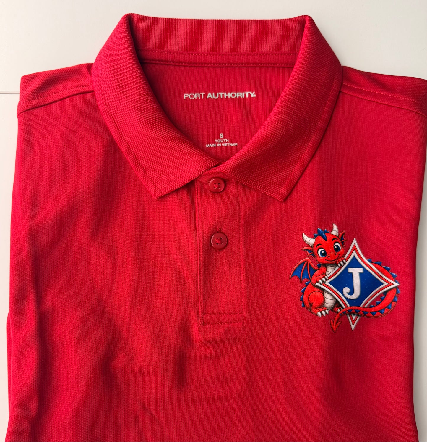 Youth Short Sleeve Moisture Wicking Polo with DTF print of Cute Dragon and Logo