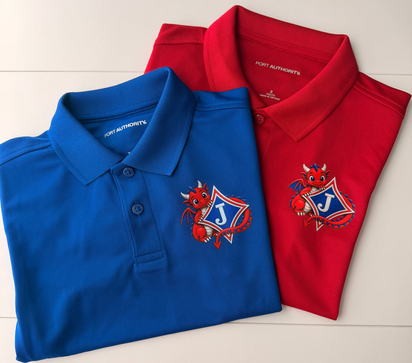 Youth Short Sleeve Moisture Wicking Polo with DTF print of Cute Dragon and Logo