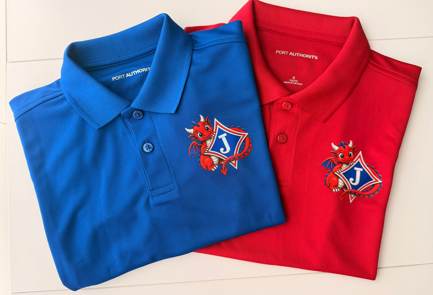Youth Short Sleeve Moisture Wicking Polo with DTF print of Cute Dragon and Logo